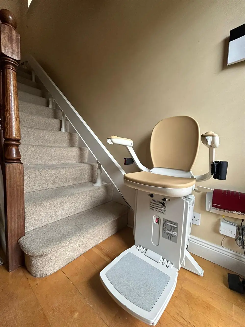 Acorn straight stairlift installed beside a light-carpeted staircase in Galway