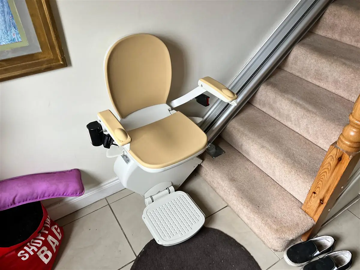 Reconditioned stairlift installed at the base of a home staircase
