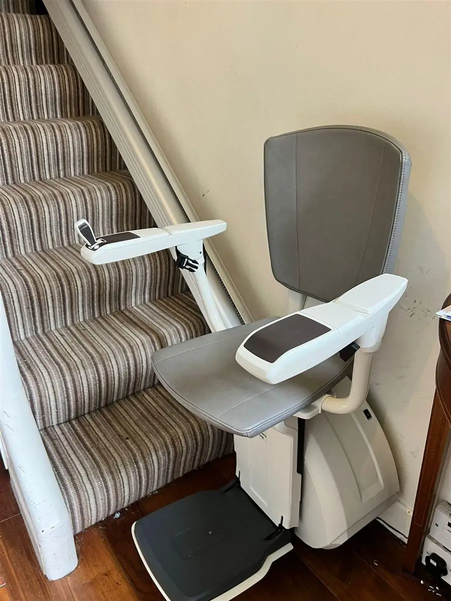 Slim straight stairlift fitted on a carpeted staircase