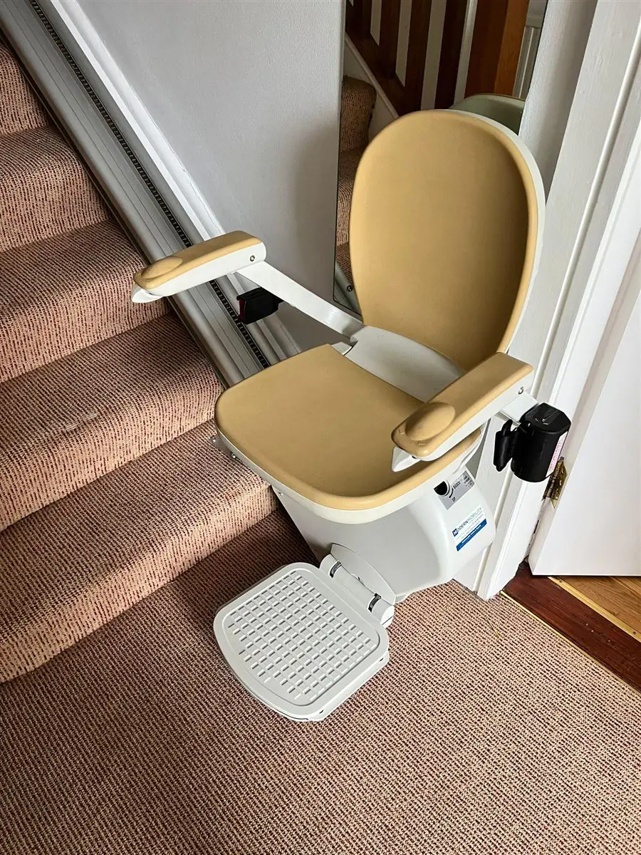 Straight stairlift ready beside a timber staircase