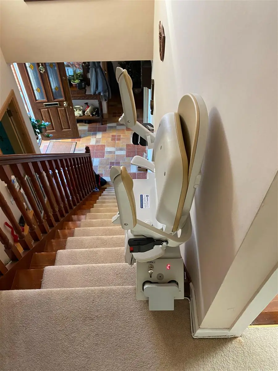 Stairlift installed to serve a staircase with a landing