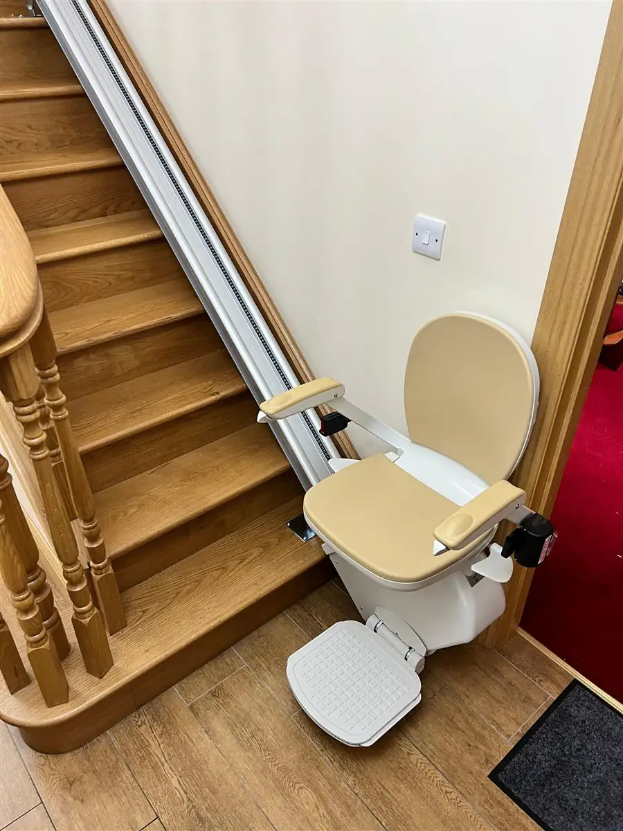 Straight stairlift alongside a long timber staircase