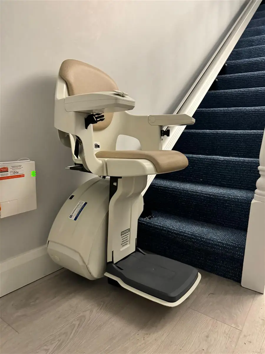 Reconditioned straight stairlift with the seat folded for space