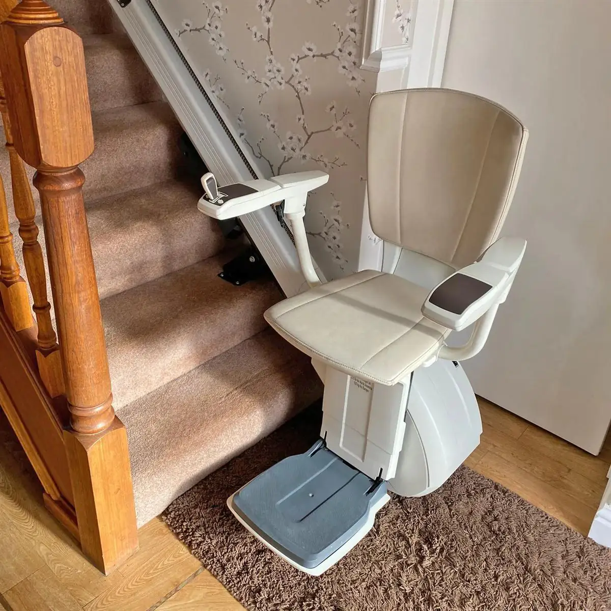 Compact reconditioned stairlift with folding arms and footrest