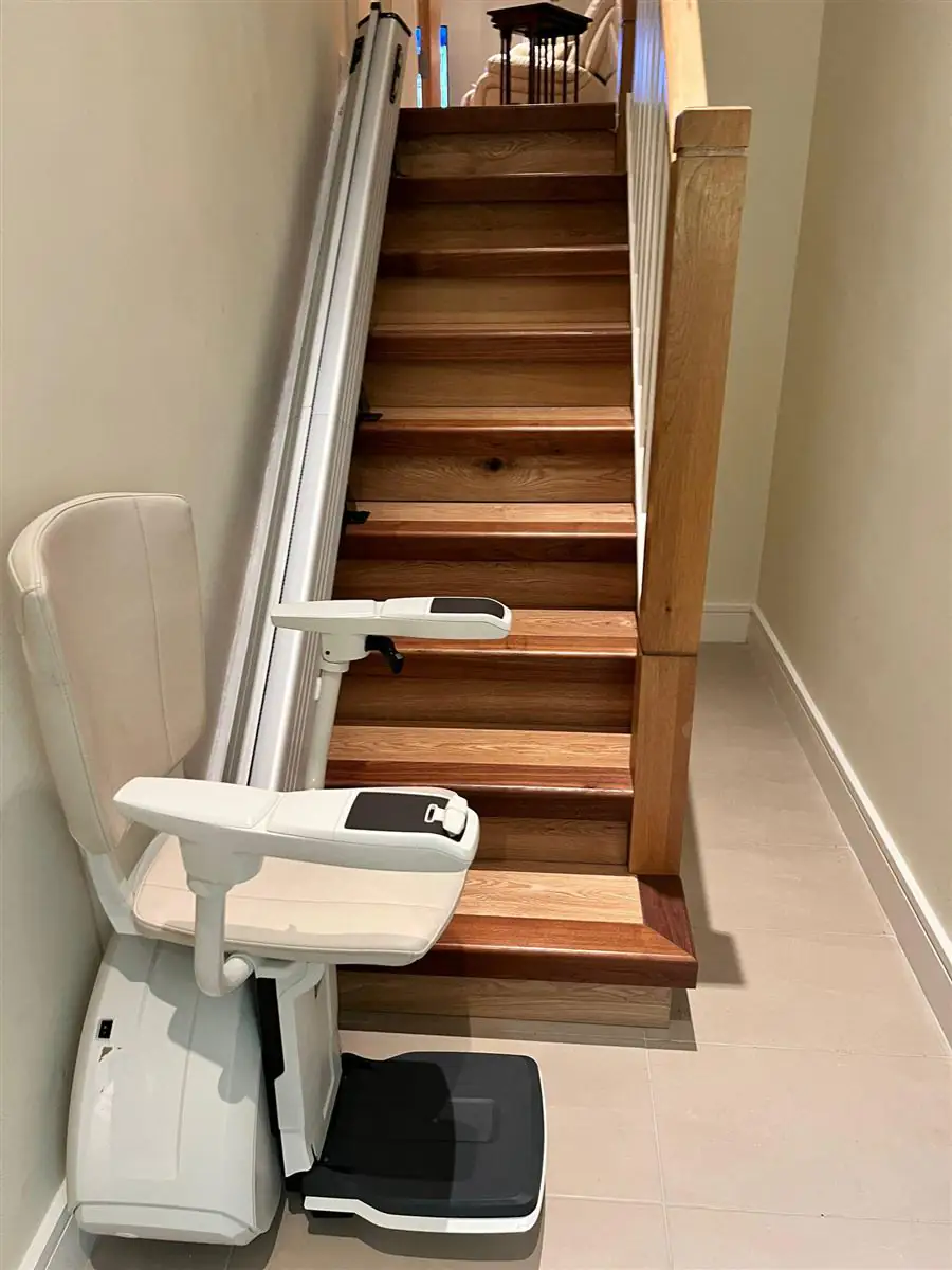 Straight stairlift fitted beside a narrow timber staircase