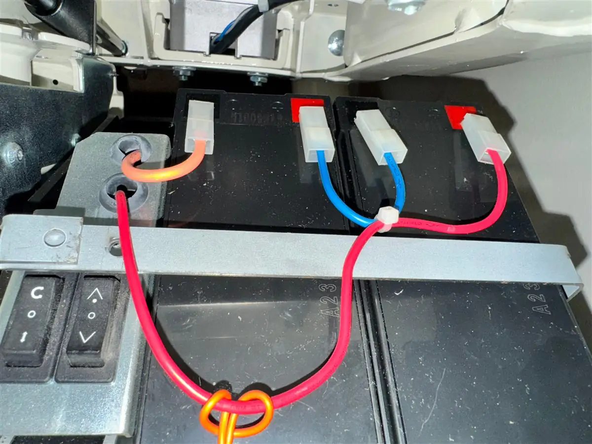 Pair of stairlift batteries connected inside the carriage